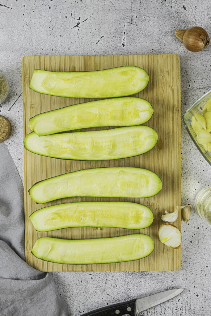 Zucchini being chopped into Zucchini Boats - Yummy Keto Cooking Zucchini being chopped into Zucchini Boats - Yummy Keto Cooking