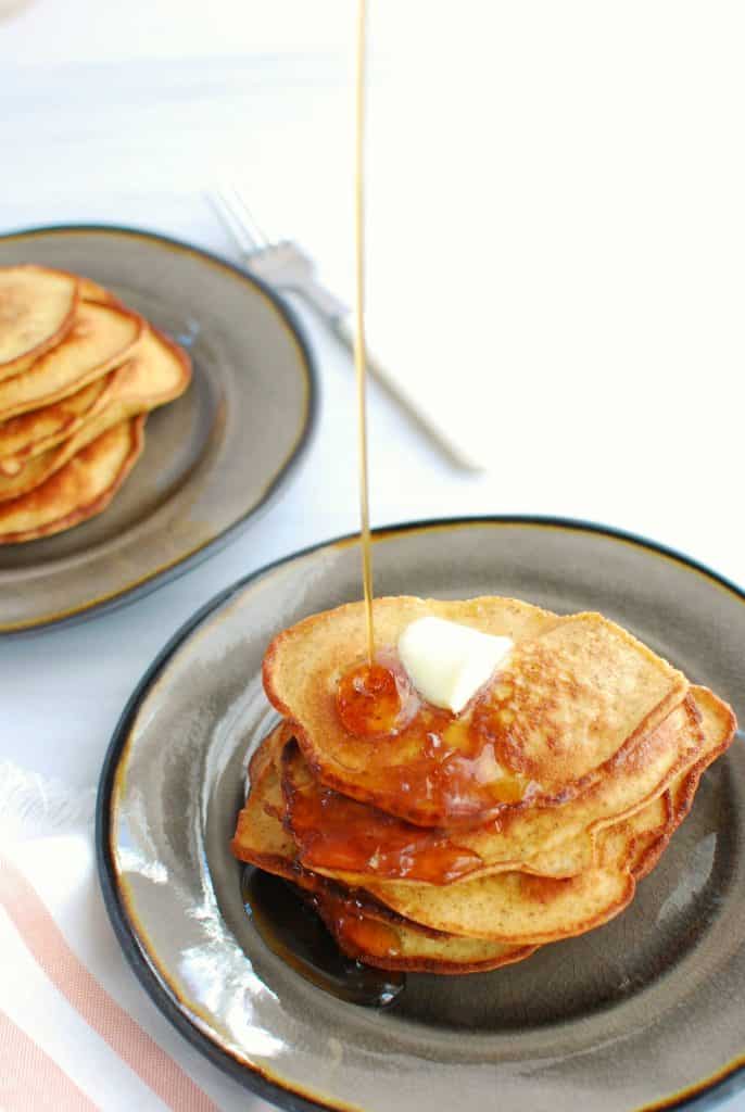 Low carb keto pancakes being drizzled with sugar free syrup Low carb keto pancakes being drizzled with sugar free syrup