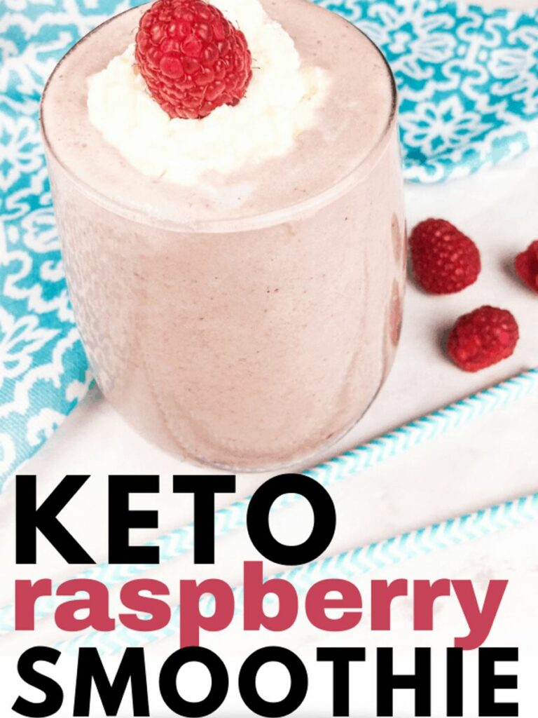 A glass filled with a keto raspberry smoothie next to a blue napkin A glass filled with a keto raspberry smoothie next to a blue napkin