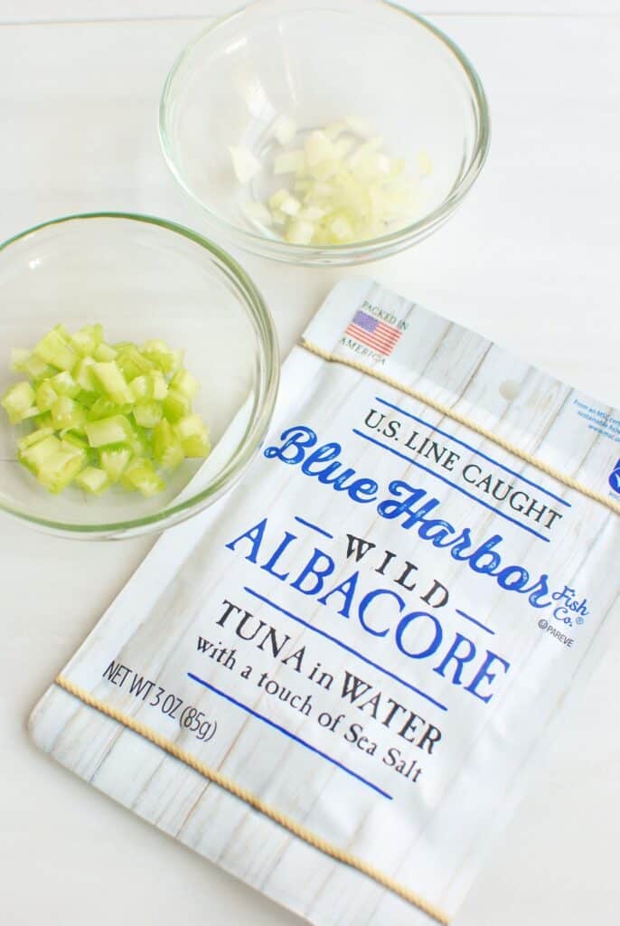 a pouch of tuna, and two prep bowls with celery and onion a pouch of tuna, and two prep bowls with celery and onion