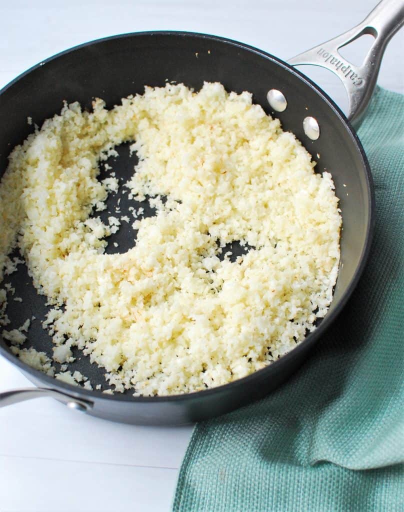 cooked cauliflower rice in a pan cooked cauliflower rice in a pan