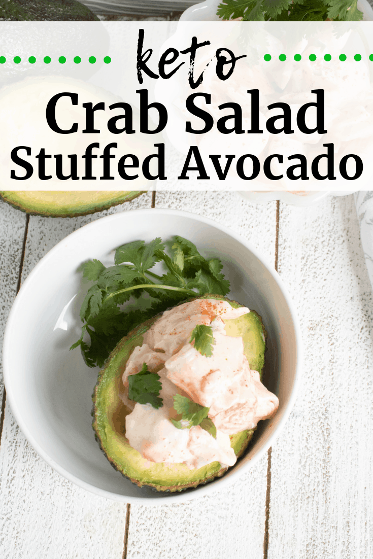 An avocado stuffed with keto crab salad and garnished with cilantro An avocado stuffed with keto crab salad and garnished with cilantro