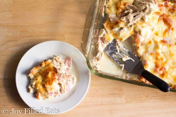 A casserole dish and a plate full of chicken cordon bleu casserole A casserole dish and a plate full of chicken cordon bleu casserole