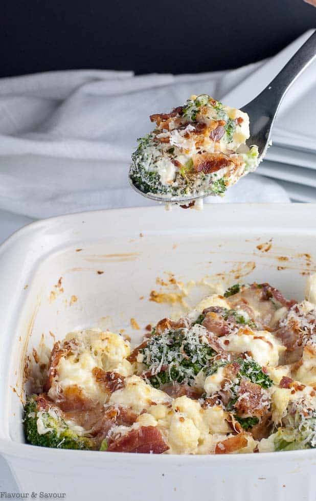 A spoonful of cheesy broccoli cauliflower casserole A spoonful of cheesy broccoli cauliflower casserole