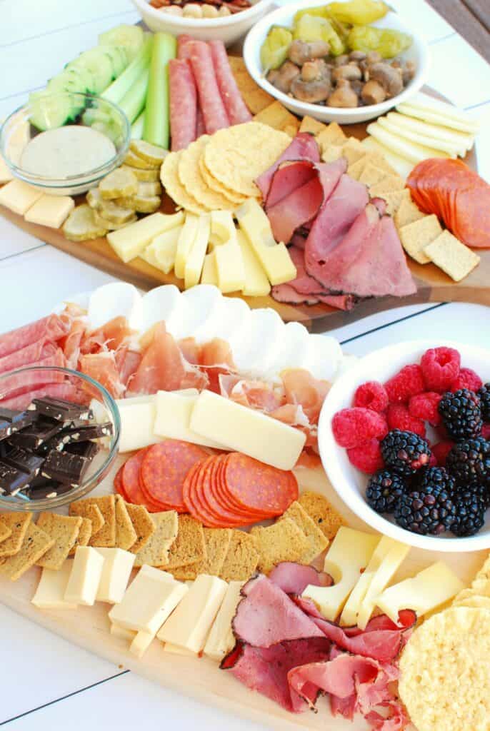 two keto charcuterie boards filled up with meats, cheeses, and other savory ingredients two keto charcuterie boards filled up with meats, cheeses, and other savory ingredients
