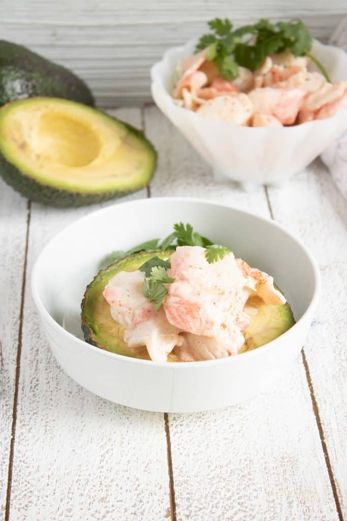 keto crab salad stuffed abocado in a white bowl keto crab salad stuffed abocado in a white bowl
