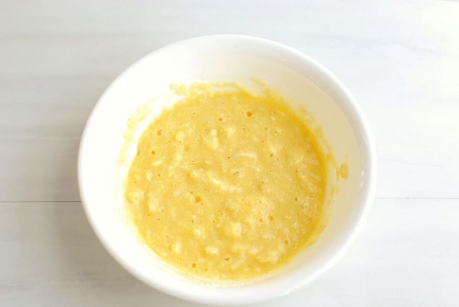 a bowl filled with a mixture of eggs, butter, almond flour, parmesan, baking powder, and salt a bowl filled with a mixture of eggs, butter, almond flour, parmesan, baking powder, and salt