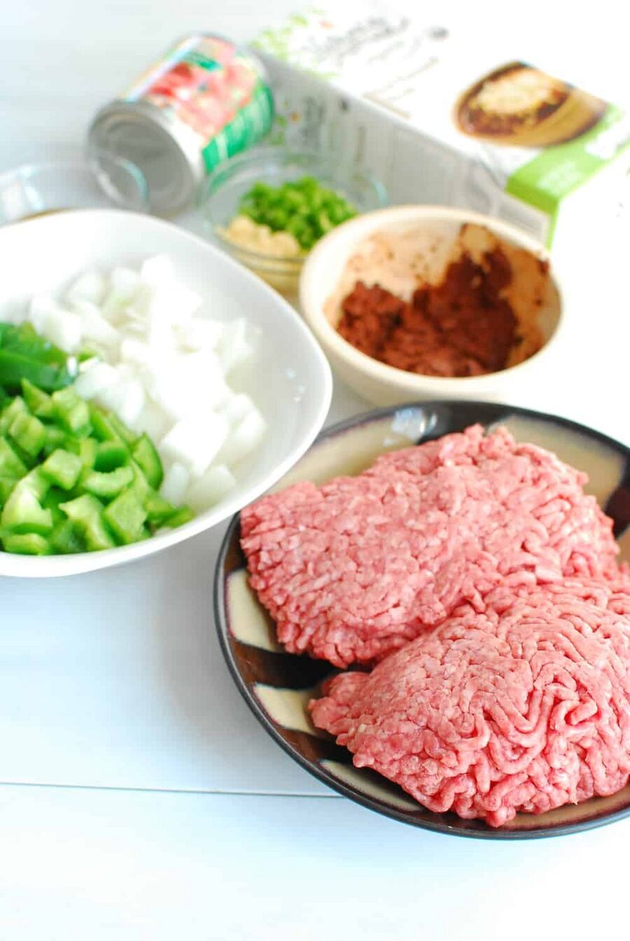 All of the ingredients needed to make chili, like beef, peppers, onions, etc. All of the ingredients needed to make chili, like beef, peppers, onions, etc.