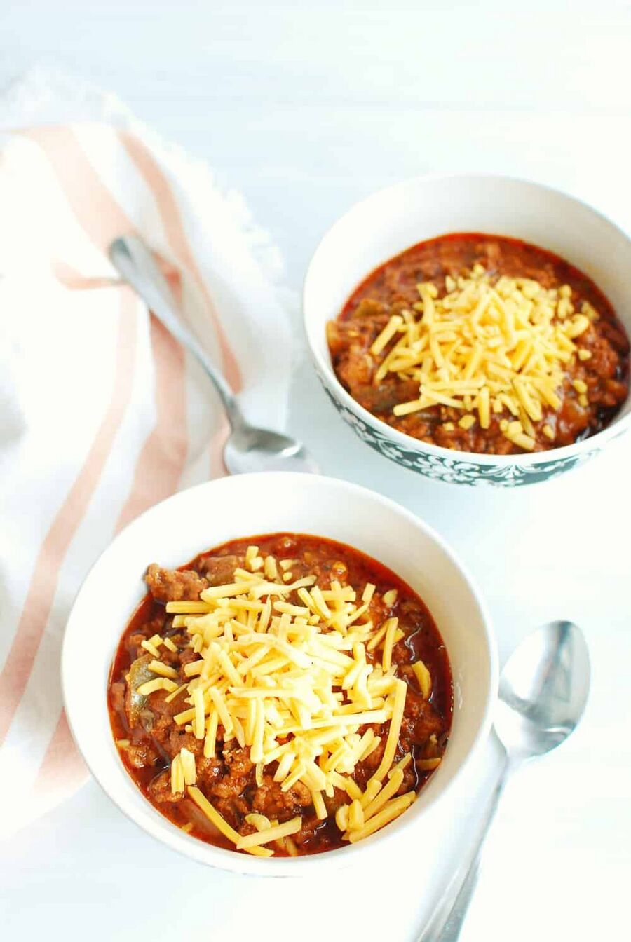 Two bowls of keto chili topped with cheddar cheese Two bowls of keto chili topped with cheddar cheese