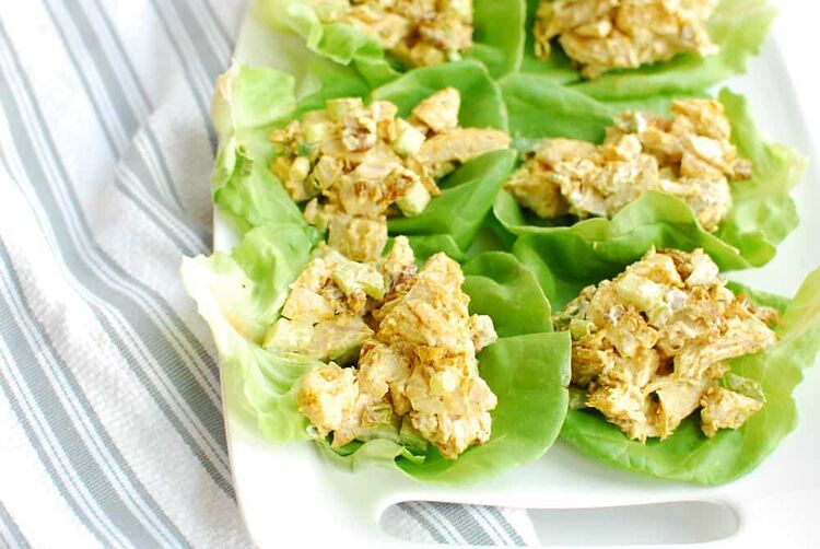 a white plate with a few keto curry chicken salad lettuce cups