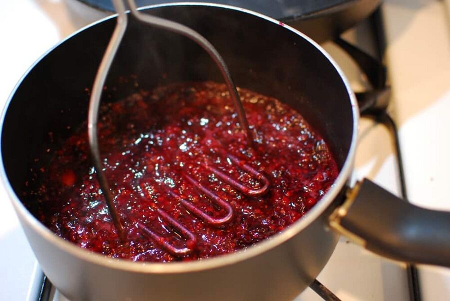 smashing blackberries in a pan to make a blackberry sauce smashing blackberries in a pan to make a blackberry sauce