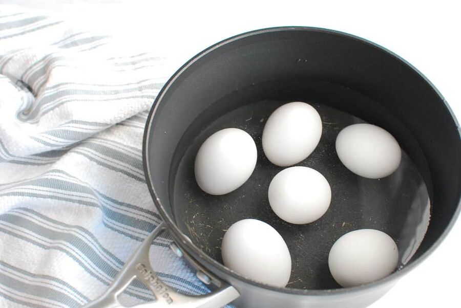 A pot filled with eggs and water in preparation to hardboil the eggs A pot filled with eggs and water in preparation to hardboil the eggs