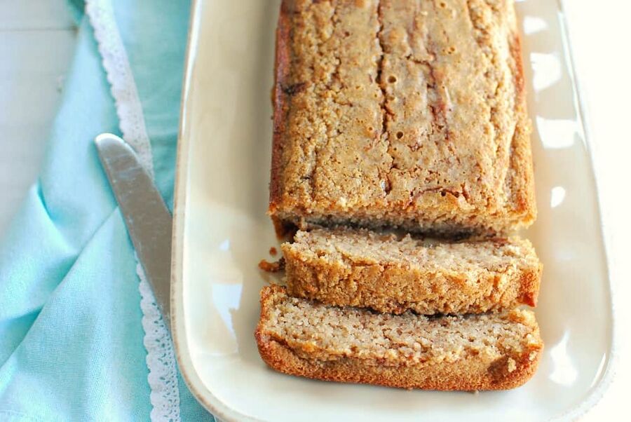 a sliced loaf of keto cinnamon bread on a beige plate a sliced loaf of keto cinnamon bread on a beige plate
