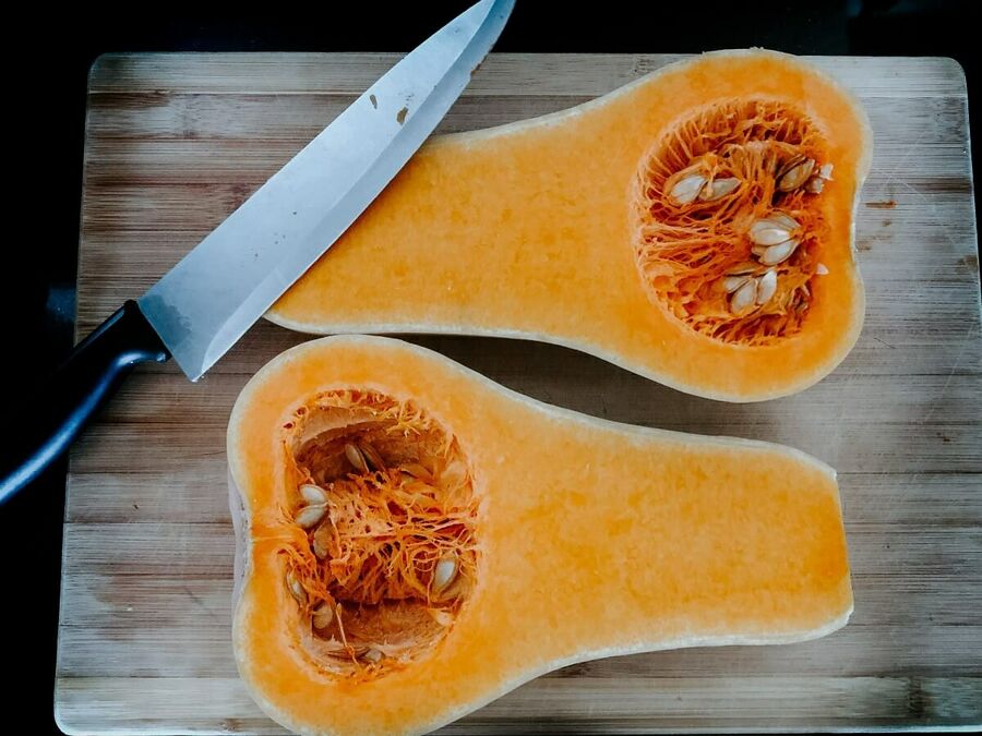 Keto Butternut Squash cut into spaghetti squash on a chopping board Keto Butternut Squash cut into spaghetti squash on a chopping board