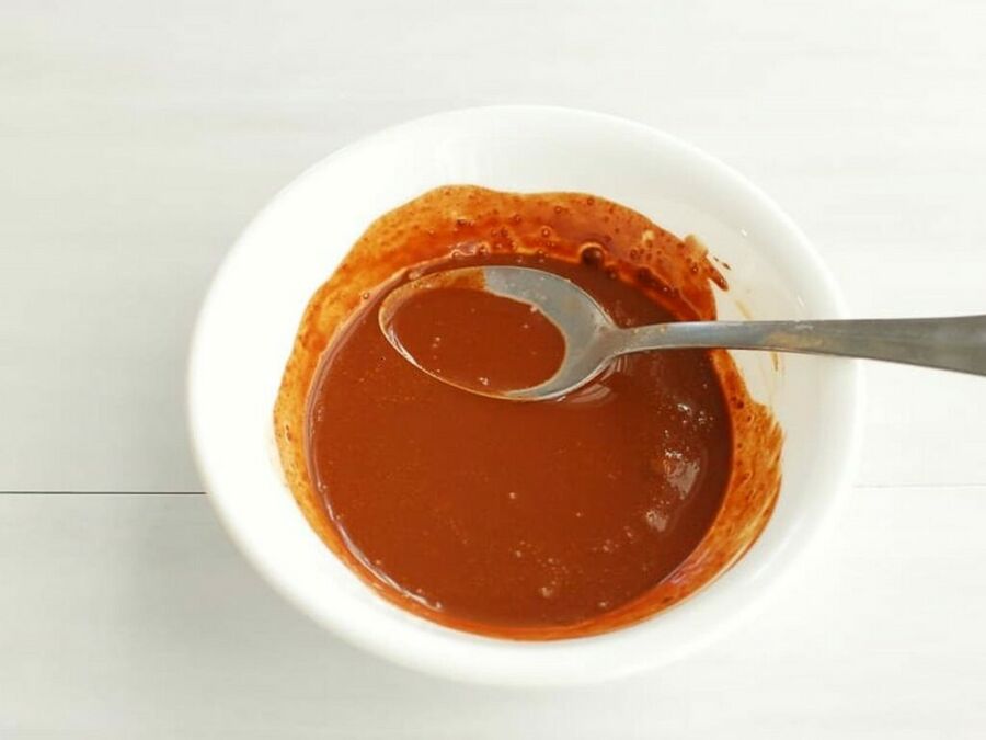 a slurry of cocoa powder and hot water in a bowl a slurry of cocoa powder and hot water in a bowl
