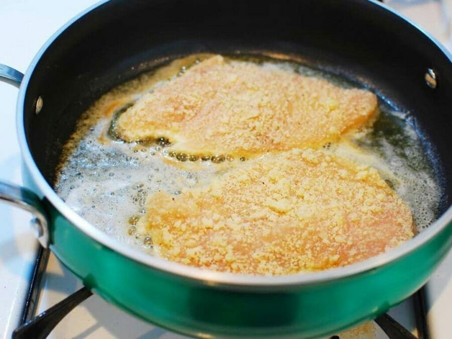 Chicken piccata recipe pan frying in a saute pan Chicken piccata recipe pan frying in a saute pan