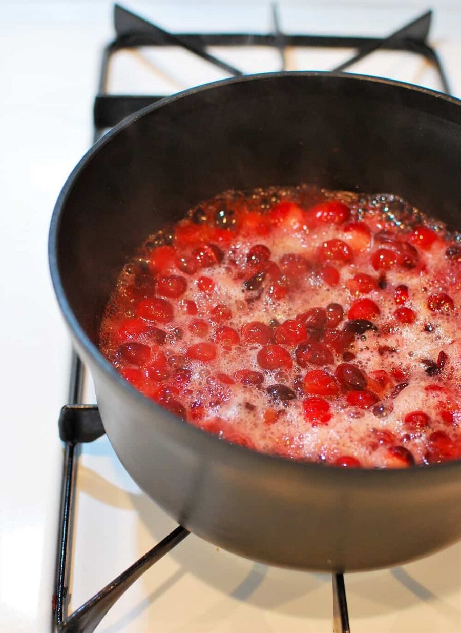 Cooking low carb cranberry sauce in a pot on the stovetop Cooking low carb cranberry sauce in a pot on the stovetop