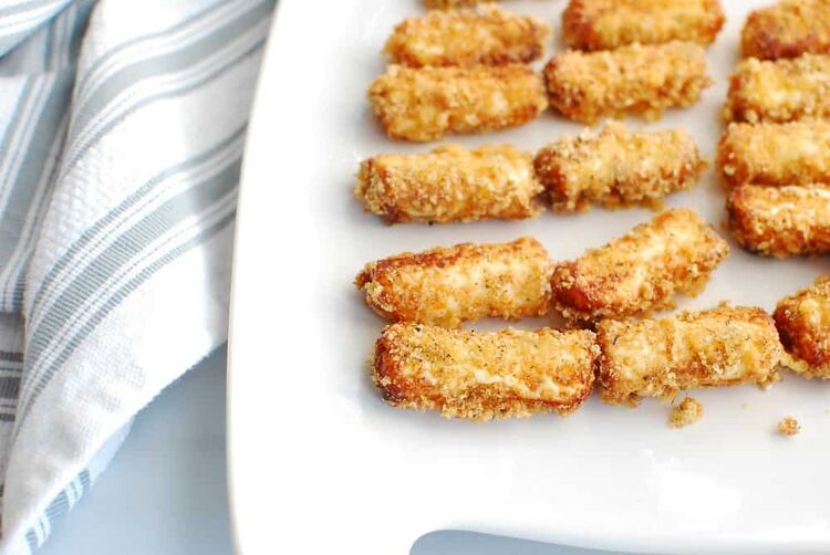 Easy homemade keto mozzarella sticks on a white platter
