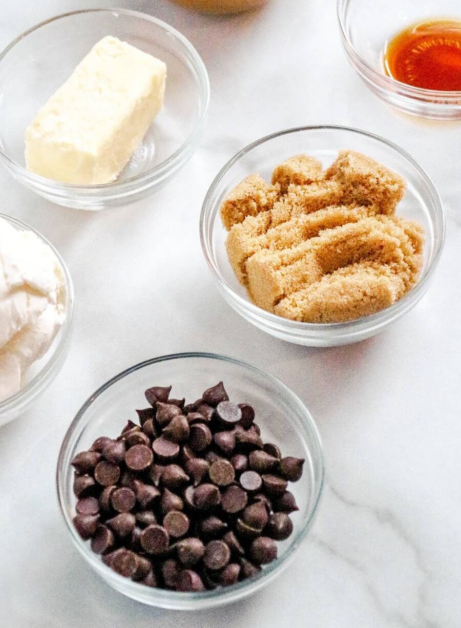 a bowl with chocolate chips, a bowl with lakanto golden sweetener, and a bowl with butter a bowl with chocolate chips, a bowl with lakanto golden sweetener, and a bowl with butter